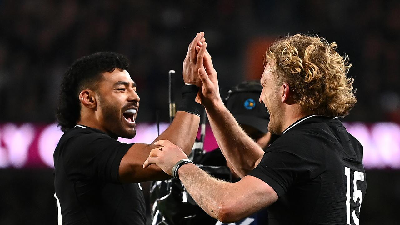 Damian McKenzie and Richie Mo'unga celebrate a try.