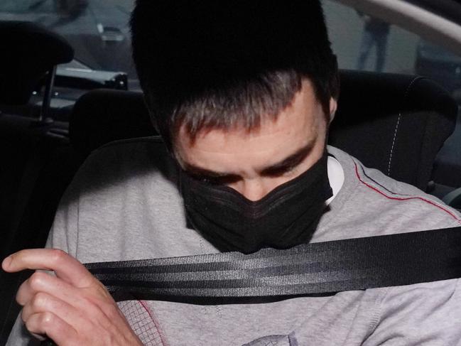 Richard Pusey, the driver of a Porsche who allegedly fled the scene of a truck crash on Melbourne's Eastern Freeway which killed four police officers, is taken away from his Fitzroy property by police in Melbourne, Thursday, April 23, 2020. (AAP Image/Michael Dodge) NO ARCHIVING