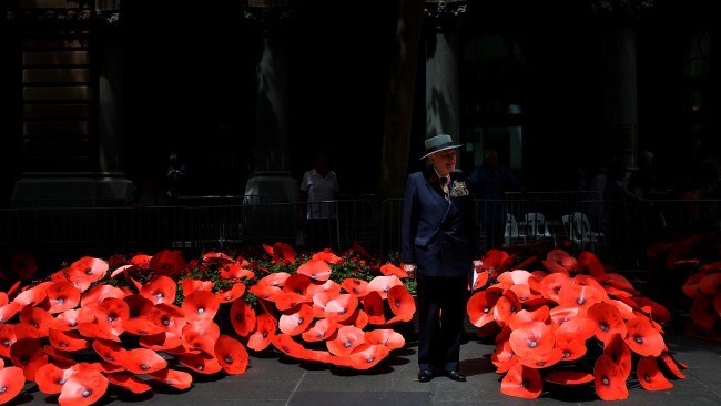 A veteran stands in front of a red poppy display in Sydney's Martin Place. Picture: NCA NewsWire / Nikki Short