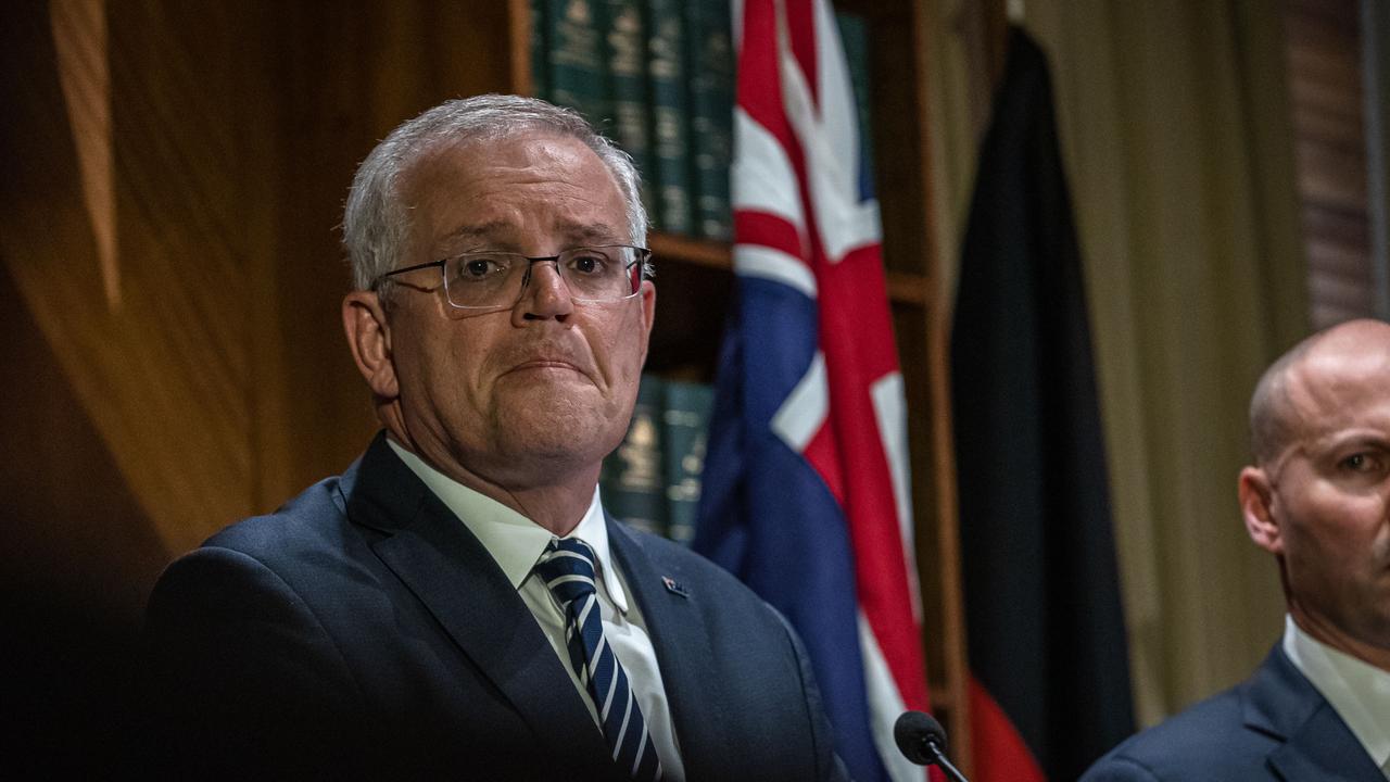 Scott Morrison white-knuckled his way through a press conference after the first interest rates rise in a decade. Picture: Jason Edwards