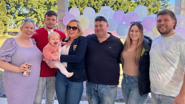 Singleton businesswoman Kylee Enwright, pictured here with family (from left): soon-to-be daughter-in-law Ellie Russell, son Harrison Lee, granddaughter Aurora Enwright (being held by Kylee), husband Paul Enwright, stepdaughter Jacinda Enwright and stepson Slade Enwright. Kylee has suffered severe head injuries in a fall in Thailand on May 28, 2023. Picture: Supplied