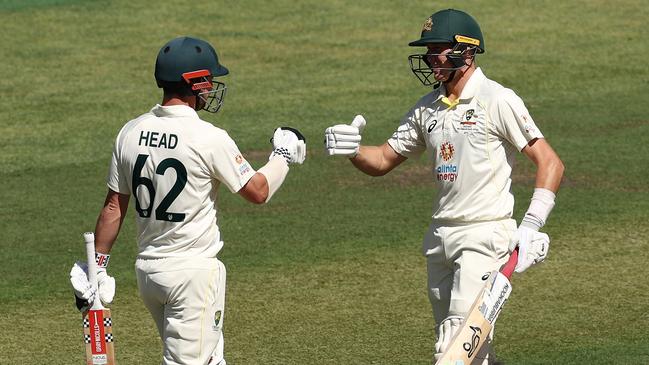 Travis Head celebrates with Marnus Labuschagne after reaching 150 runs during day two at Adelaide Oval. Picture: Matt King/Getty Images