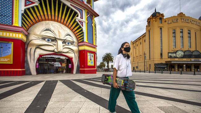 A skateboarder walks past Luna Park on Sunday afternoon. Picture: NCA NewsWire/David Geraghty