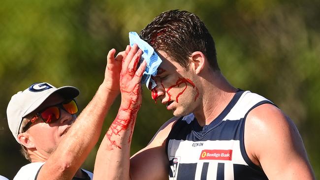 Josh Jenkins receives treatment from a trainer after the friendly fire.