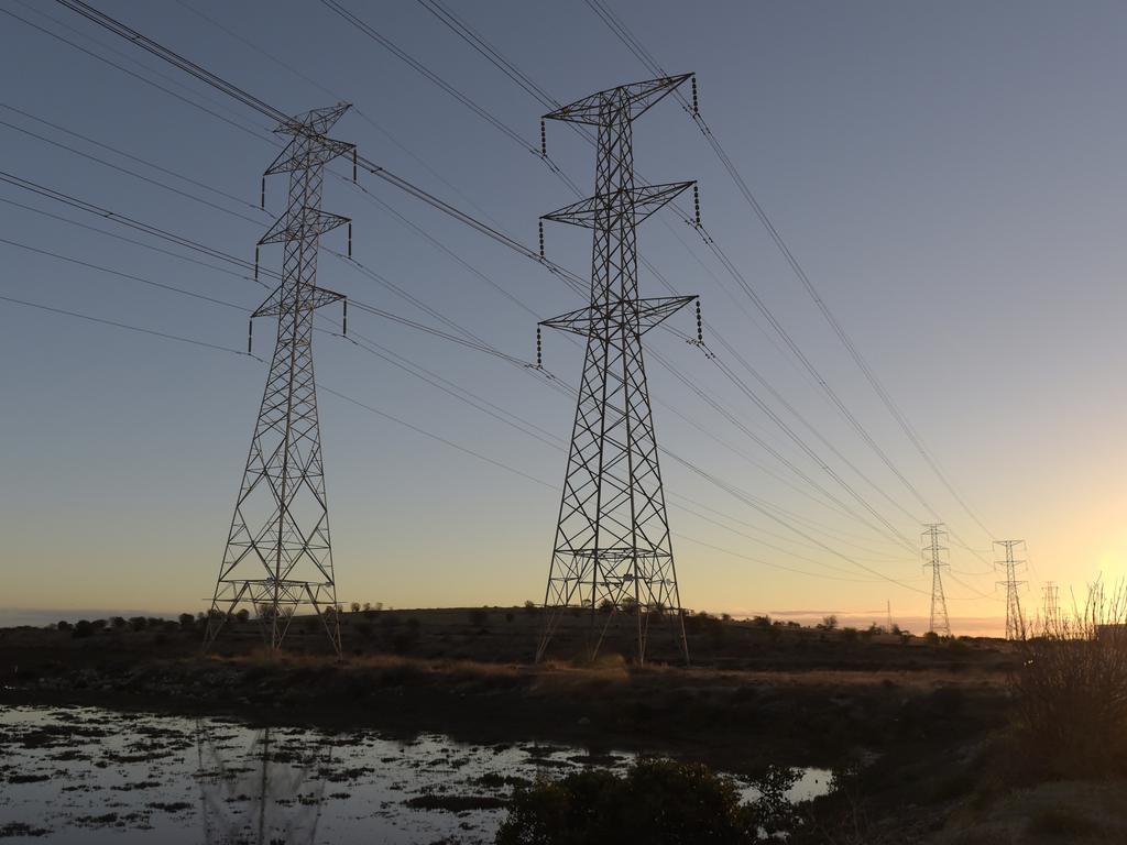 Power lines hang from transmission towers on Torrens Island, South Australia. Picture: Carla Gottgens/Bloomberg via Getty Images