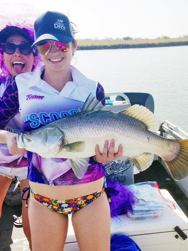 Team Scoop It’s Jess Ley cradles her beaut 70cm-plus barra while teammate, Amanda Pernachele, shows her delight.