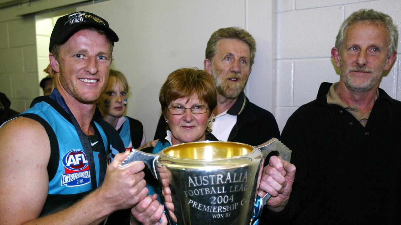 Damien Hardwick poses with his mum Pam and dad Noel after the 2004 premiership win.