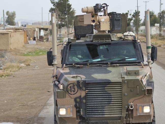 AFGHANISTAN .. Afghan children wave hello to Australian Defence Force members in an Australian Army Bushmaster Protected Mobility Vehicle as it drives through the streets of Kandahar heading towards Camp Hero, Afghanistan, as part of the NATO-led Resolute Support mission. *** Local Caption *** There are approximately 20 Australian Defence Force personnel providing training and advisory support as mentors at Camp Hero, Kandahar. Australian troops are also deployed to Afghanistan as part of Operation Highroad to provide force protection and security to Australian and Coalition mentors and advisers supporting the NATO-led Resolute Support mission. The force protection elements act in a variety of ways such as close support ‘Guardian Angels’ as well as in more traditional protection roles. The risk of insider threat remains a key consideration for ADF members operating in Afghanistan. There are force protection elements located in Kandahar, Kabul and Qargha. Members of the force protection element are currently drawn from B Company, First Battalion, Royal Australian Regiment, based in Townsville. There are approximately 400 Australian Defence Force personnel deployed across Afghanistan in a variety of roles as part of Operation Highroad contributing to Resolute Support. Resolute Support is focused on training, advising and assisting the Afghan National Security Forces and Afghan security institutions at the operational, institutional and ministerial levels.