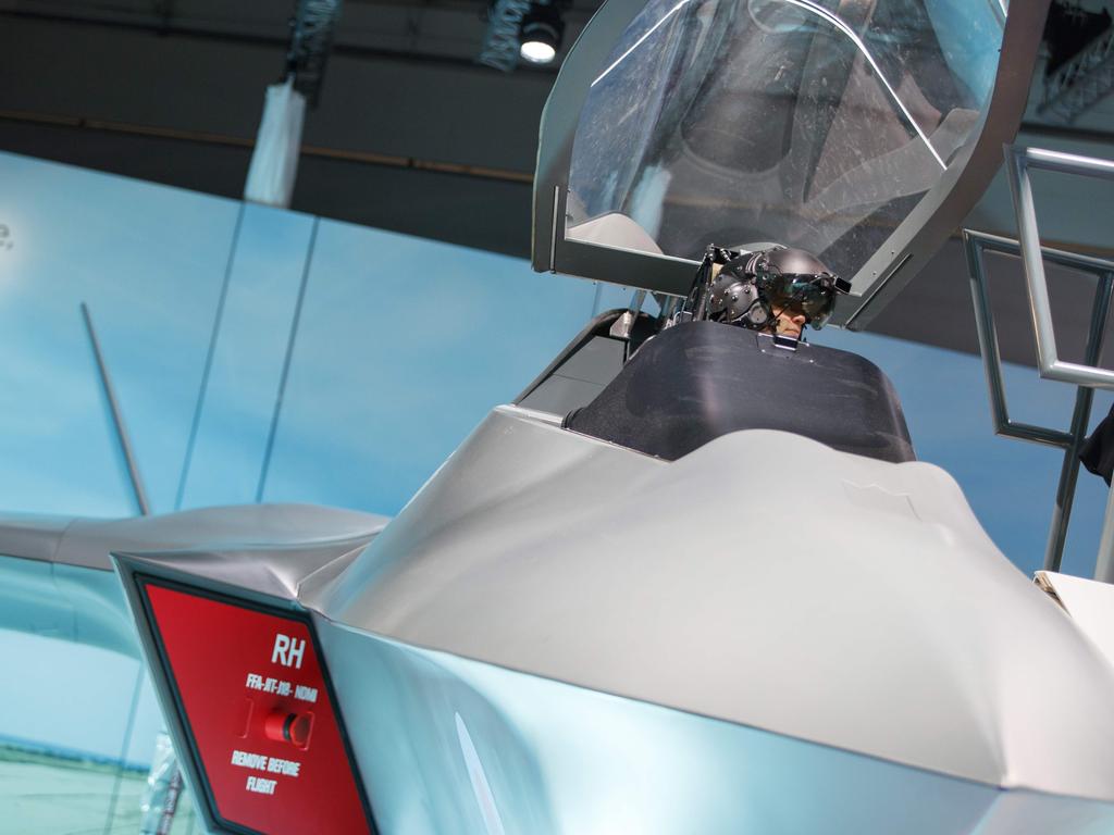 A visitor sits in the model of a new fighter jet, a part of Team Tempest, during the Farnborough Airshow. Picture: AFP