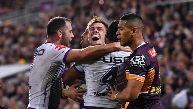 Ryan Papenhuyzen of the Storm (centre) celebrates scoring a try with teammates during the Round 20 NRL match between the Brisbane Broncos and the Melbourne Storm at Suncorp Stadium in Brisbane, Friday, August 2, 2019. (AAP Image/Dan Peled) NO ARCHIVING, EDITORIAL USE ONLY