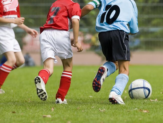 Children playing soccer, with four players in action.