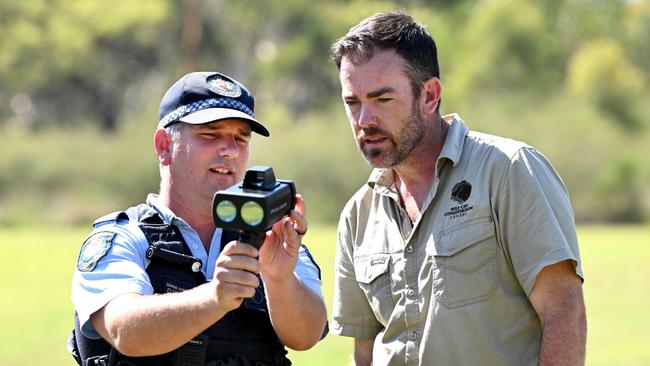 Senior Constable Dave Romeike shows his Lidar’s readings to Wild Cat Conservation Centre director Ben Britton. Picture: Gregg Porteous