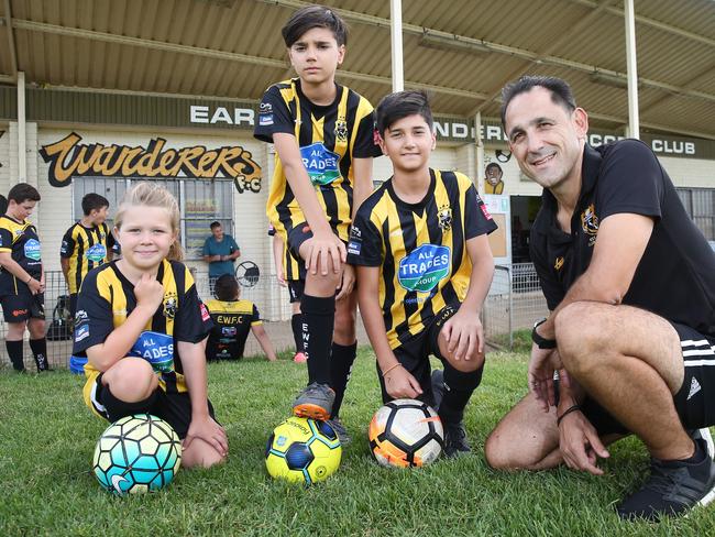 Earwood Football Club president George Markos with players Molly Nash, Athan Makris, and Sam Makris. The club is being forced to play 12 teams on the one field at any one time due to explosion of members. Picture: Richard Dobson