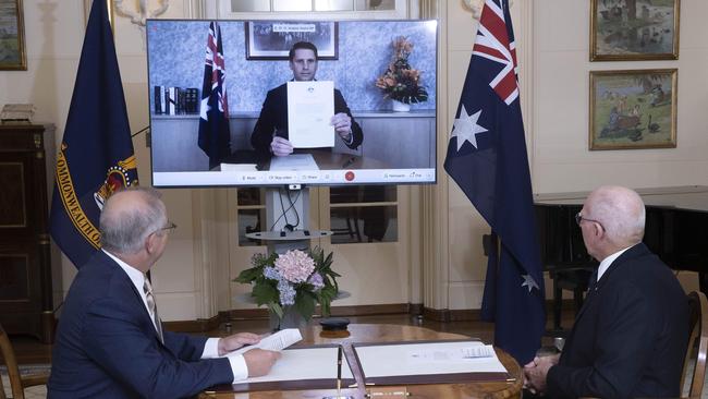 Scott Morrison, left, and Governor-General David Hurley swear in Coalition minister Andrew Hastie via video on Tuesday. Picture: Gary Ramage