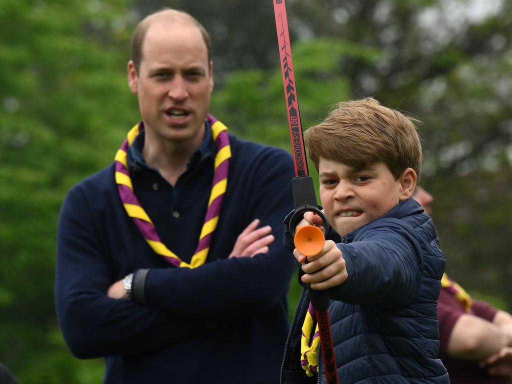 Watched by his father Prince William, Prince of Wales, Prince George of Wales tries his hand at archery while taking part in the Big Help Out. Picture: Getty Images