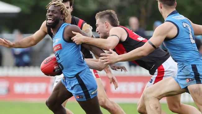 Sturt’s Martin Frederick tries to break the tackle of West Adelaide’s Joel Stevens at Unley Oval on Sunday. Picture: SANFL Image/David Mariuz