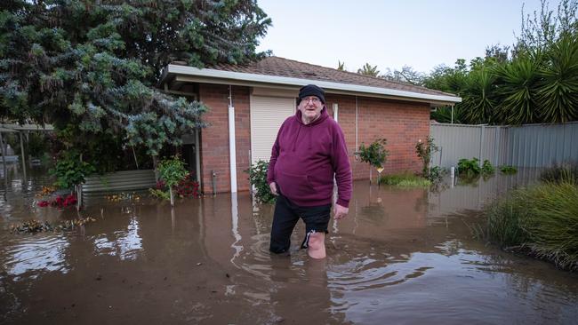 Ian Moore, 73, wades through knee-deep in Rochester. Picture: Jason Edwards