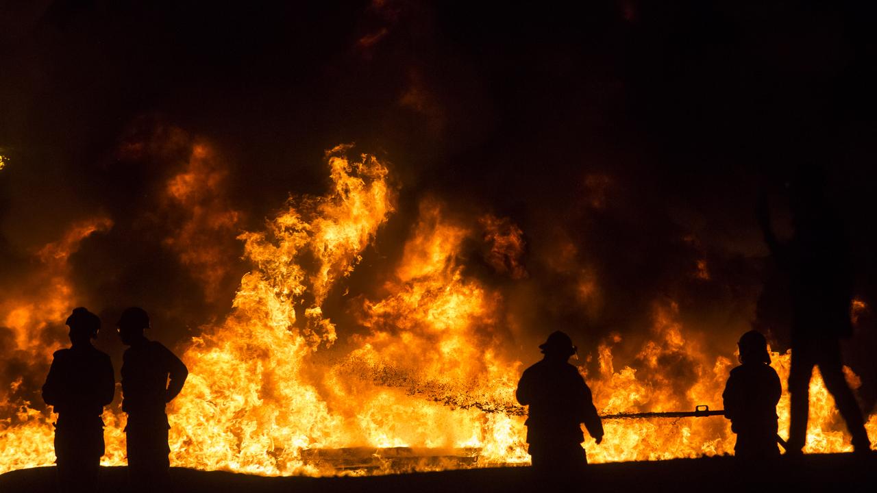 Israeli firefighters battle a field fire after a rocket launched from Gaza Strip struck on May 13, 2021 in Ramla, Israel. Picture: Amir Levy/Getty Images