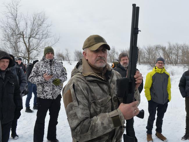 An instructor teaches civilians to shoot with AK-47 rifles and pump-action shotguns during shooting training outside the Ukraine city of Kharkiv. Picture: AFP