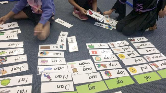 Children work with phonics cards.