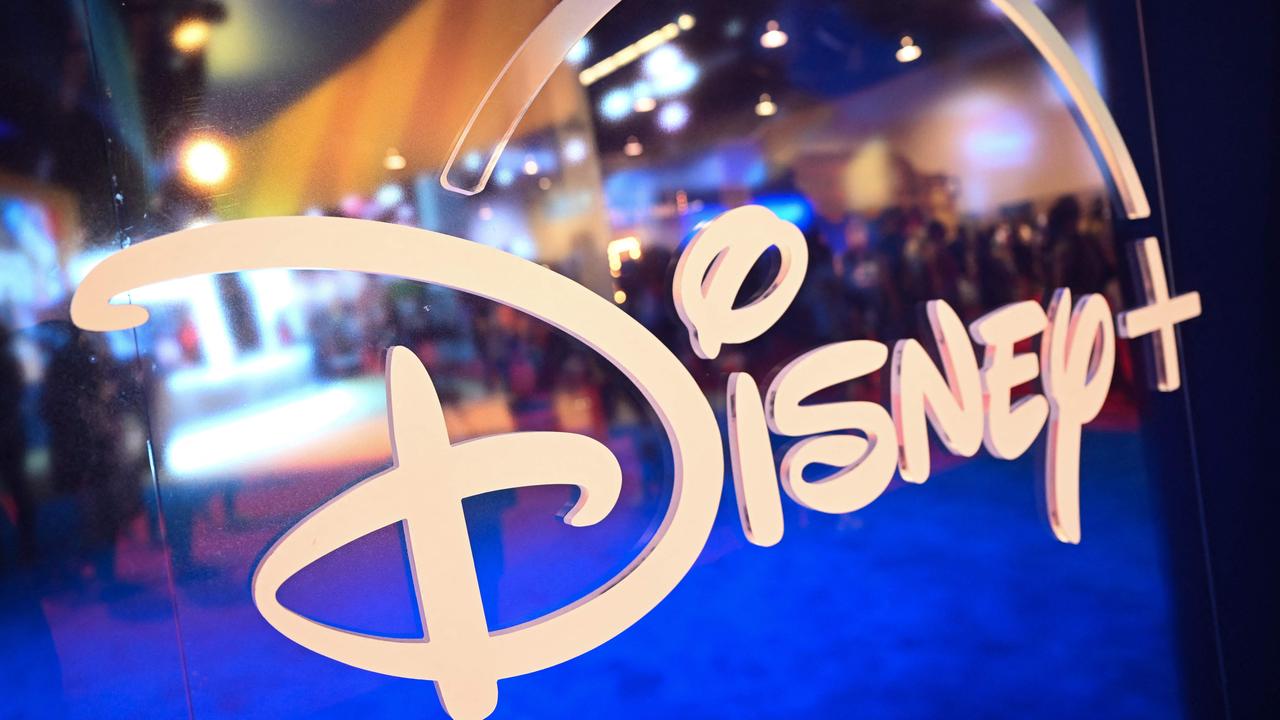 (FILES) Fans are reflected in Disney+ logo during the Walt Disney D23 Expo in Anaheim, California on September 9, 2022. Disney reported on August 7, 2024, better revenues than anticipated in the most recent quarter, atop a first profit in its streaming business, while its theme parks came under pressure. The company saw revenues of $23.2 billion, beating projections of $23.1 billion, while overall profits reached $2.6 billion. (Photo by Patrick T. FALLON / AFP)