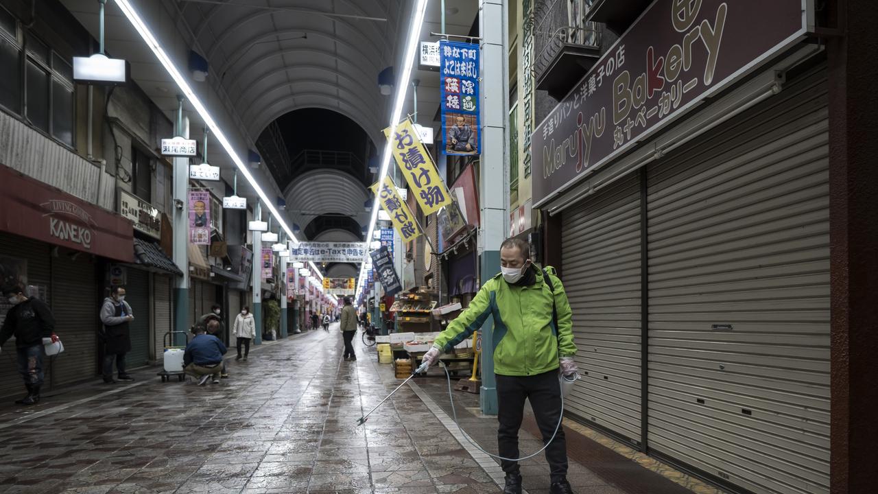 A shop owner sprays disinfectant at the Yokohamabashi Shopping District on March 6, 2020 in Yokohama, Japan. Picture: Tomohiro Ohsumi/Getty Images