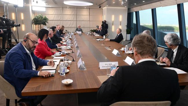 Vladimir Putin (R) speaks with heads of International news agencies in Saint Petersburg. Picture: AFP.