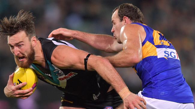 Charlie Dixon marks in front of the Eagles’ Shannon Hurn during last year’s Elimination Final at Adelaide Oval. Dixon is keen to make the trip to Perth for the JLT Community Series hitout. Picture: AAP Image/David Mariuz