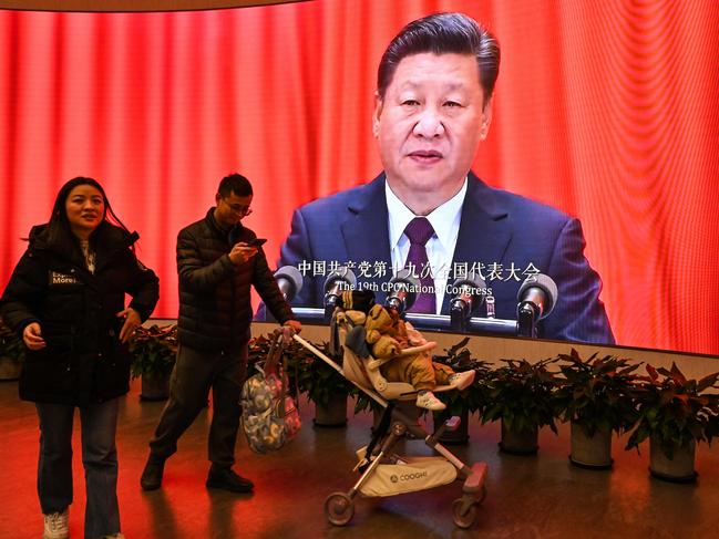 A screen shows images of China's President Xi Jinping as people visit the Museum of the First National Congress of the Chinese Communist Party in Shanghai on February 27, 2025, ahead of the opening of the annual session of the National Peopleâs Congress on March. (Photo by HECTOR RETAMAL / AFP)