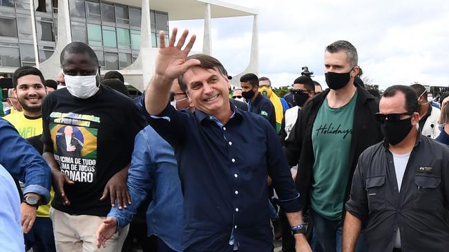 An unmasked Jair Bolsonaro greets supporters in Brasilia on Sunday. Picture: AFP