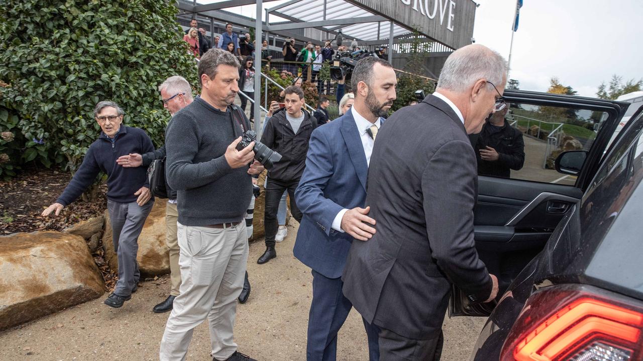 The PM’s security approach Mr Sofield as they rush Mr Morrison into a car. Picture: Jason Edwards