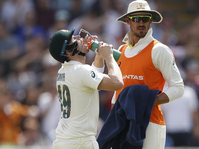 BIRMINGHAM, ENGLAND - AUGUST 01: Mitchell Starc of Australia runs drinks to Steve Smith of Australia during Day One of the 1st Specsavers Ashes Test between England and Australia at Edgbaston on August 01, 2019 in Birmingham, England. (Photo by Ryan Pierse/Getty Images)