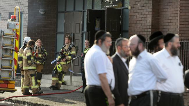 People gather outside a synagogue at East St Kilda after an overnight fire. Picture: Andrew Henshaw