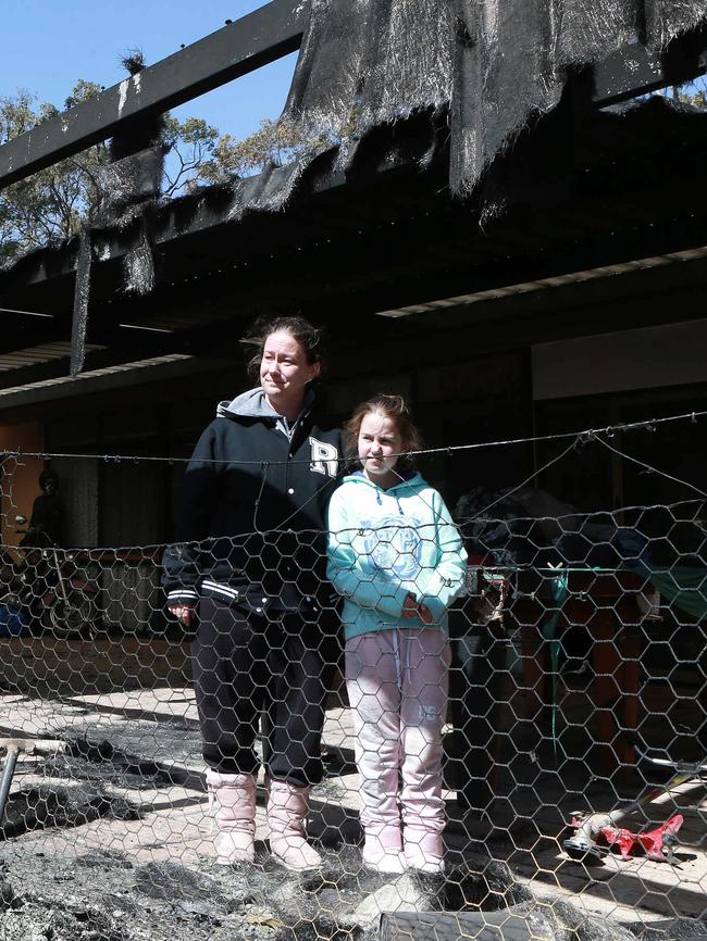 Lana Estreich and her daughter, Isabella Quirk, 9, outside their damaged Caves Rd, Stanthorpe, home. Picture: AAP/Image Sarah Marshall