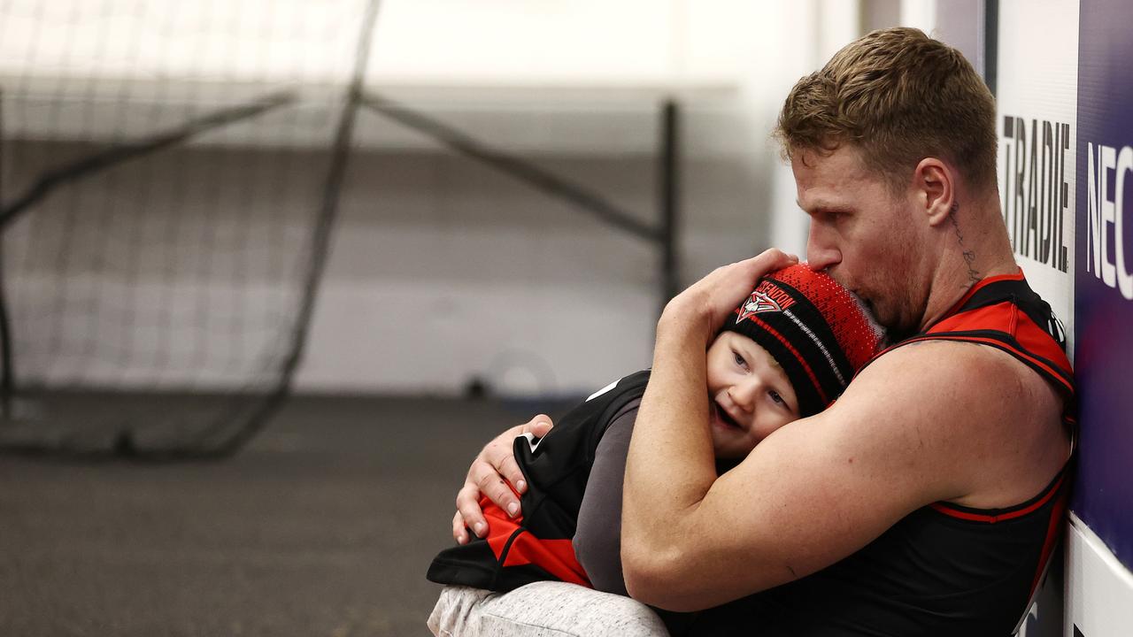 Jake Stringer of the Bombers shares a quite moment with son River.