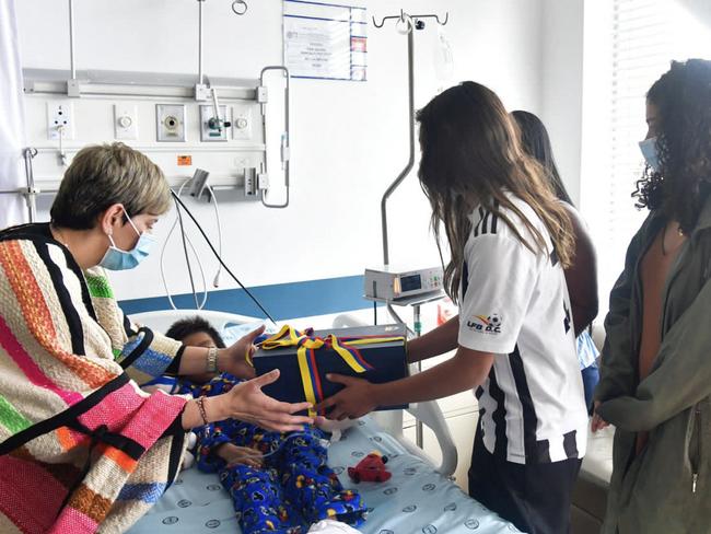 Colombia's First Lady Veronica Alcocer (left) and Sofia Petro (right), daughter of Colombian President Gustavo Petro, visiting one of the four indigenous children found alive after being lost for 40 days in the Colombian Amazon rainforest following a plane crash. Picture: AFP.