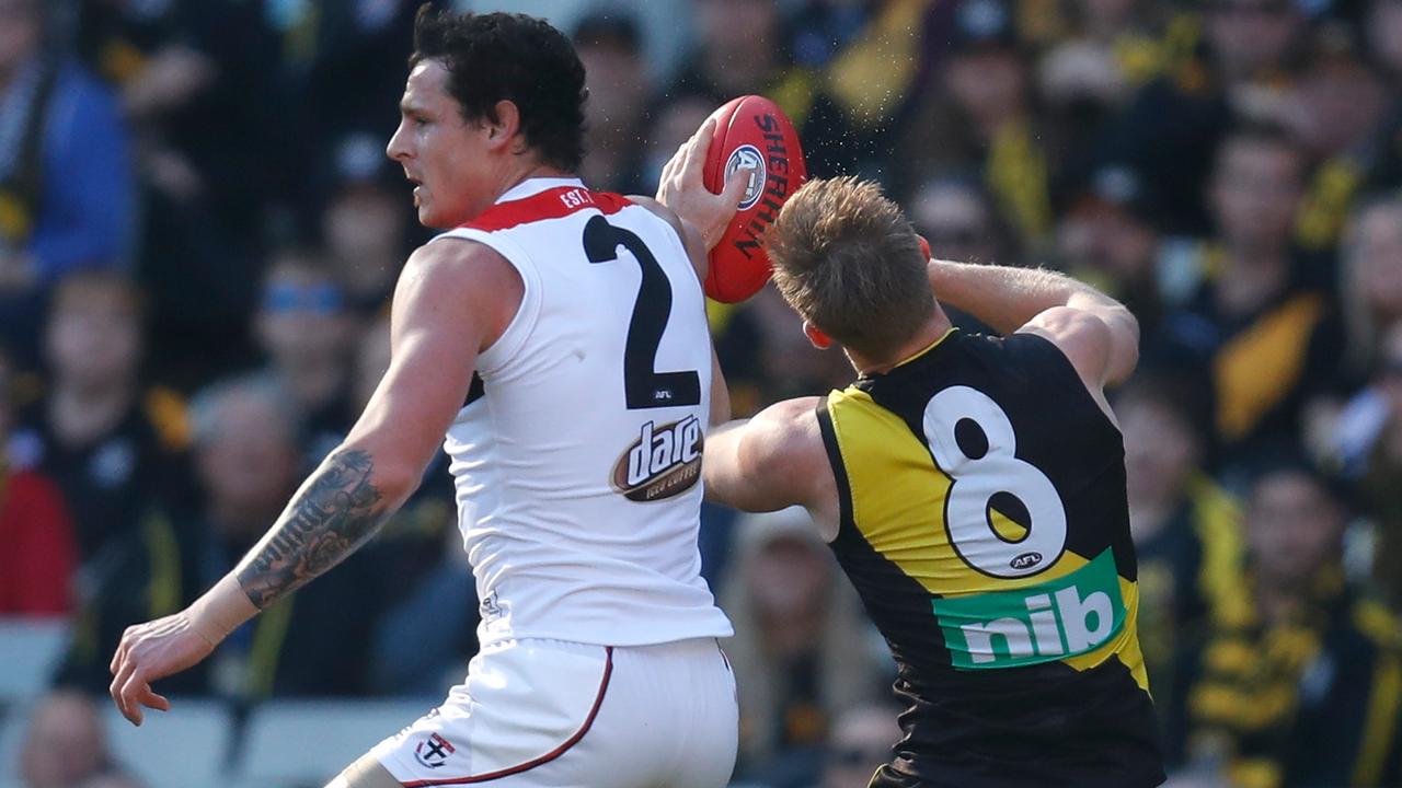Jake Carlisle of the Saints takes Jack Riewoldt of the Tigers high.