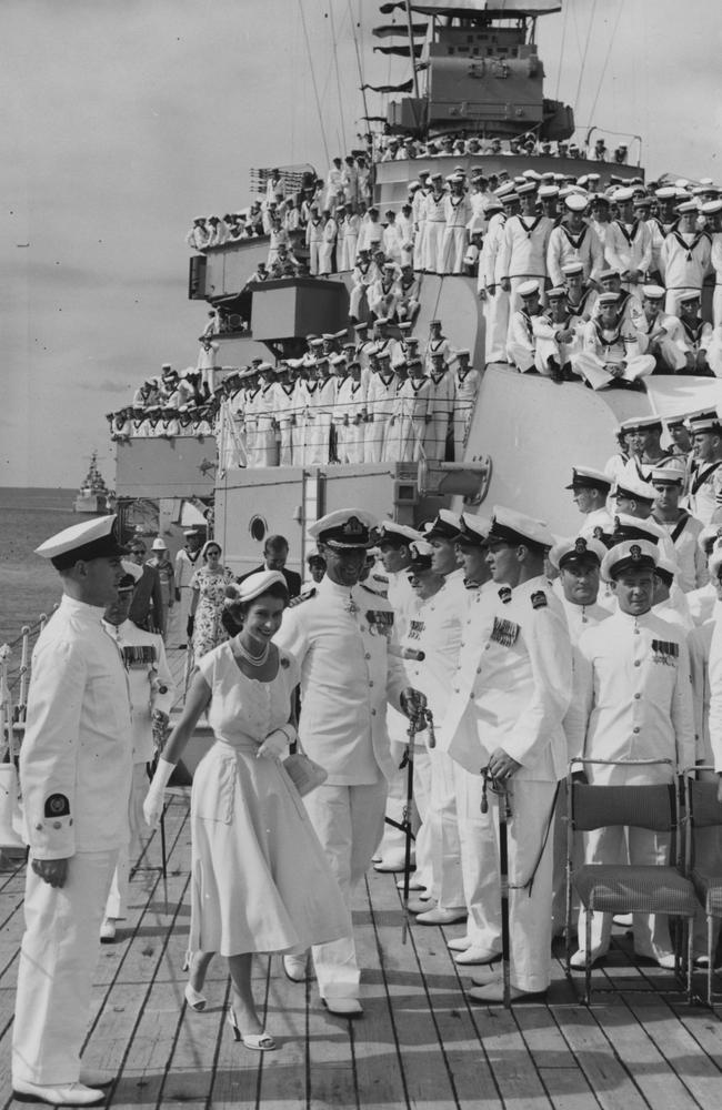 Queen Elizabeth II and Prince Philip on board HMAS Australia at sea off Townsville, Queensland, during a royal tour of Australia on March 13, 1954. Captain A W R McNicoll, commander of the ship, is on the left. Picture: Central Press/Getty Images