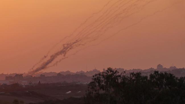 A picture taken from the southern Israeli side of the border with the Gaza Strip shows rockets fired from the Palestinian enclave towards Israel. Picture: JACK GUEZ/AFP