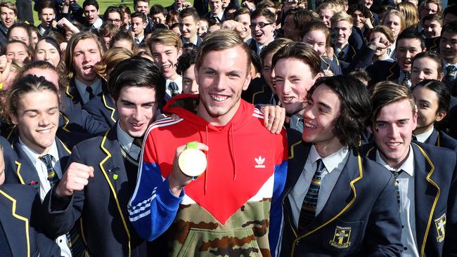 Kyle Chalmers is mobbed by schoolmates at Adelaide’s Immanuel College. Photo Calum Robertson