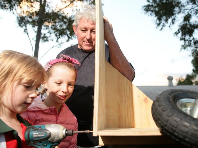 Steve Elliott keeps an eye as Amelia and Abigail Barber learn how to make a billy cart..