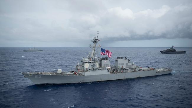 The Arleigh Burke-class guided-missile destroyer USS Benfold (DDG 65), front, Republic of Singapore Navy’s (RSN) RSS Supreme (FFS 73), left, and RSS Endurance (LST 207), right, participate during Exercise Pacific Griffin 2017, off the coast of Guam in August.