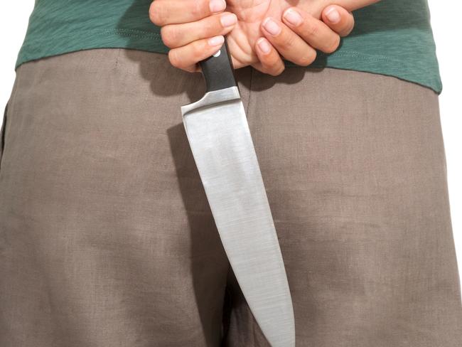 woman detail back with a big knife on her hands