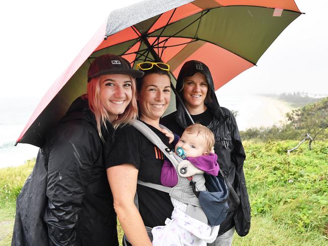 WEATHER: Out and about in the rain at Point Cartwright are Kendra Froese, Leilan and Zoe Power, 8 months with Jill Dallin. Photo Patrick Woods / Sunshine Coast Daily.