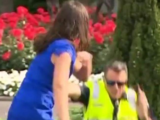 Melbourne Cup race-goer is arrested by Victorian Police after she pushed over Acting Superintendent Steven Cooper at Flemington Racecourse.