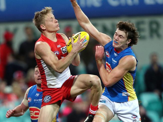 Sydney's Isaac Heeney   marks in front of Suns' Charlie Ballard  during AFL match Sydney Swans v Gold Coast Suns at the SCG. Picture. Phil Hillyard