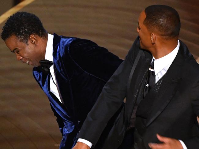 -- AFP PICTURES OF THE YEAR 2022 --  US actor Will Smith (R) slaps US actor Chris Rock onstage during the 94th Oscars at the Dolby Theatre in Hollywood, California on March 27, 2022. (Photo by Robyn Beck / AFP) / AFP PICTURES OF THE YEAR 2022