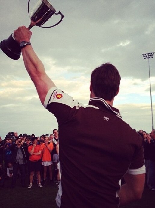 Travis Ronaldson lifts the premiership cup as Old Ivanhoe coach.