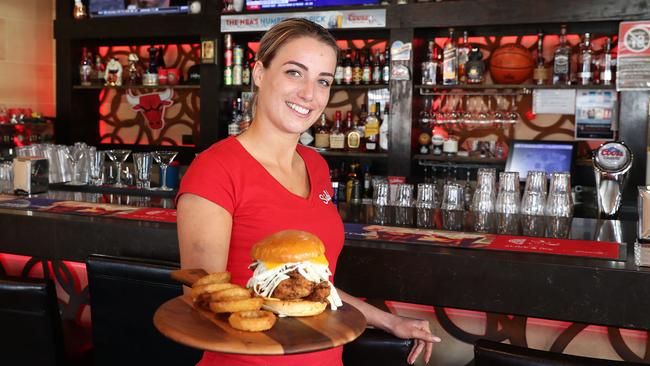 Mandy de Wit serves up a Usain Bolt burger at Sidelines Sports Bar. Picture: Brett Costello