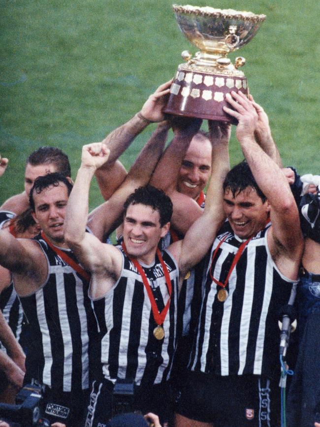 Port players Tim Ginever and Greg Phillips hold the Thomas Seymour Hill trophy aloft after beating Glenelg in 1992.